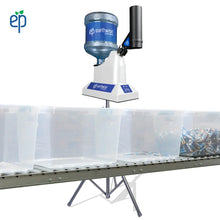 Load image into Gallery viewer, SST Machine behind a heavy duty gravity roller conveyor system with storage bins on top.
